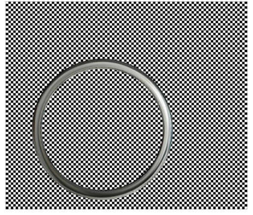A magnifying lens holder placed over a checkerboard pattern.