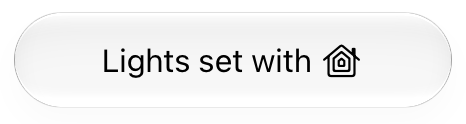 The third in a series of images showing examples of the HomeKit icon when used in text. This example depicts the icon incorrectly positioned at the end of the line of text that reads 'Lights set with'.